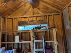 the inside of a house being built with wooden walls and ceiling joists in place