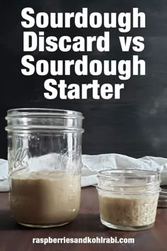 two jars filled with liquid sitting on top of a table