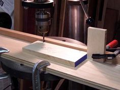 a workbench with some tools on it and a piece of wood next to it