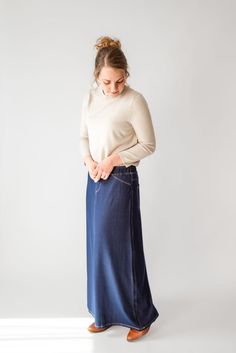 With the look of real denim but the feel of soft knit, comfort is the key element in our Caroline skirt. The quick, effortless pull-on style makes this skirt an effortless option for every day. Larger waist-size? The elastic waistband gives stretch without feeling bulky. A skirt like this will take you through the day, from grocery shopping to making dinner, or even a quick coffee shop visit for a chat with a friend over lattes! This skirt has become a best-seller. Style: elastic waist, soft knit fabric, functioning back pockets Color: navy denim Fabric content: 65% Cotton, 30% Polyester, 5% Spandex Care instructions: wash gentle cycle, cold; lay flat to dry, cool iron if needed. Our sizing is always approximate and can also vary due to personal preference and body shape. Please allow a 1" Christian Clothes, Making Dinner, Quick Coffee, Apostolic Fashion, Be Intentional, Knit Maxi Skirt, Modest Clothing, Denim Maxi Skirt, Long Knit