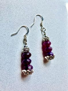 These beautiful drop earrings feature amethyst rondelle beads and silver floral bead cap accents. They are one inch long and dangle from nickel-free French ear wires. Nickel-free Purple Beaded Round Earrings, Silver Beaded Earrings With Bead Caps For Gift, Silver Beaded Earrings With Faceted Beads, Czech Glass Dangle Earrings With Bead Caps, Purple Czech Glass Jewelry With Dangling Beads, Silver Earrings With Round Beads And Bead Caps, Silver Earrings With Bead Caps And Round Beads, Silver Round Beaded Earrings With Faceted Beads, Nickel-free Purple Sterling Silver Beaded Earrings