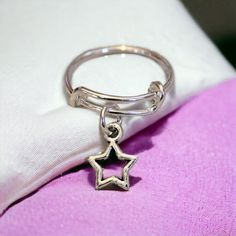 This elegant little Sterling Silver ring expands from size 5 to 7 or from size 8 to 10. A tiny Star charm dangles on this trendy ring. Clip on different charms for a new look every day! Great as a gift or treat yourself! See more at https://ladybugfeetdesigns.com Star Charm Ring Jewelry Gift, Star-shaped Jewelry With Dangling Charms For Gift, Cute Silver Jewelry With Star Charm, Adjustable Star-shaped Midi Rings As Gift, Cute Silver Star Jewelry, Cute Adjustable Jewelry With Star Charm, Cute Jewelry With Star Charm For Gifts, Cute Star Charm Jewelry Gift, Silver Star Charm Jewelry For Birthday