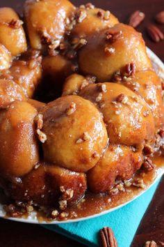 a bundt cake on a plate with pecans around it