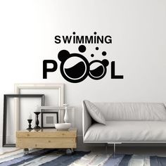 a living room with a couch and wall decal that says swimming pool on it