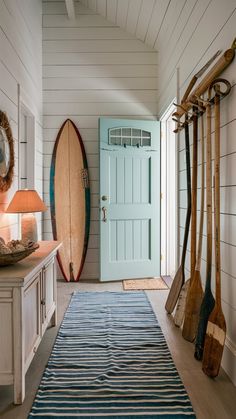 there is a blue door and some surfboards on the wall in this room,