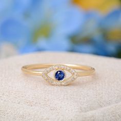 Description : Handmade Solid Gold Blue Sapphire Evil Eye Ring, Dainty Blue Sapphire Evil Eye Ring, Evil Eye Ring Solid Gold Diamond, Devil Eye Ring Natural Diamond : 0.05 CT. F / SI (26 piece) Natural Sapphire : 0.10 CT. (1 piece) Gram 1.29 (It may differ depending on the ring size) Product Code: MR0011636-SP This product belongs to Tilya Jewelery private collection . You can browse our store for other special collection products. All of our products are stamped and made of solid gold . All of o Blue Diamond Stackable Ring, Blue Stackable Diamond Ring, Blue Stackable Birthstone Ring For Promise, Blue Diamond Stackable Promise Ring, Blue Stackable Diamond Promise Ring, Blue Birthstone Promise Ring Stackable, Blue Crystal Promise Ring In Fine Jewelry Style, Blue Sapphire Stackable Birthstone Ring, Blue Crystal Promise Ring Fine Jewelry