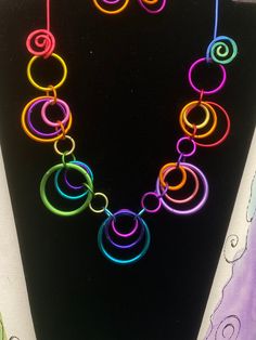 A rainbow of color in circles make up this fun and funky necklace.  Length is about 20 inches and the closure is looping the ring on the side over the aluminum swirl.  photo is an example.  Yours will be in random  multi colors.   earrings are sold separate.  Check listings Hoop Necklace, Funky Necklace, Rings Necklace, Crafty Ideas, A Rainbow, Necklace Length, Ring Necklace, Multi Colored, Circles