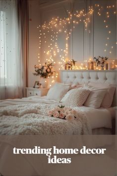 a white bed sitting in a bedroom next to a window with lights on the wall