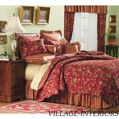 the bed is made with red and gold comforters