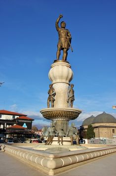 there is a statue on top of the fountain