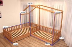 a bed frame with measurements for the top and bottom sides, in front of a curtained window