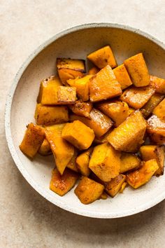 a white bowl filled with cooked sweet potatoes