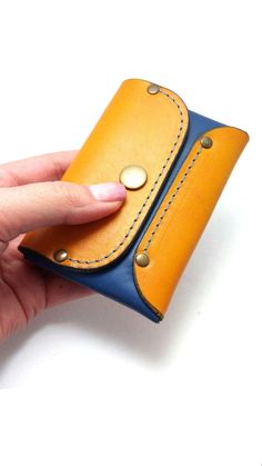 "This original coin purse & wallet is made of blue and orange genuine leather with blue thread. Securely holds 6 -8 cards, bussines cards, ID, some cash and coin . Purse is skillfully handcrafted with genuine 100 % Leather from our hands. The hand stitch is blue coloured waxed thread finished with rivets, which must guarantee for non tearing. Wallet closes with one snaps (press button) This item is an elegant handmade style that suitable for both men and women. Size of the case: closed 8.5 c Handmade Blue Wallet For Everyday Use, Handmade Blue Rectangular Coin Purse, Blue Rectangular Card Holder For Personal Use, Blue Handmade Wallet, Handmade Blue Wallet, Blue Coin Purse With Card Slots For Gift, Handmade Blue Rectangular Wallet, Orange Leather Wallet As Gift, Orange Rectangular Wallet With Interior Card Slots