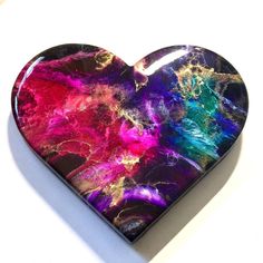 a heart shaped box with colorful paint on it