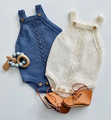 two pairs of baby clothes on a white background