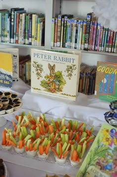 there are many books and desserts on the table