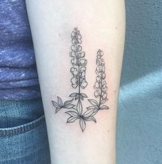 a woman's arm with three flowers on it