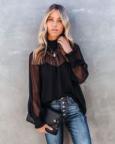 Relaxed Fit Self & Lining¨C 100% Polyester Hand Wash Cold. Hang dry High Neckline Long Sleeves with Button Cuffs Crepey Fabrication Back Keyhole with Neckline Button Closure Lined Body Only¨C Chest. Upper Back and Sleeves are Unlined/Sheer Lock down your holiday look in the Locket Sheer Ruffle Blouse! This dramatic black blouse has a ruffled high neckline and ruffle cuffs. Finished with a keyhole back button closure. Wear this top out to date night paired with black skinny denim and heels. Styled with the Michaela Hoops. Initial Card Necklace. Stallion Chain Necklace. Stella Crossbody Envelope Zip Clutch. Tilley Frayed Ankle High Waisted Skinny and Whimsy Heel.---SIZE AND FIT---Model is Wearing a Size Small. Height is 5'9". Bust is 32". Waist 24.5". and Hips 34" Size S: Length measures 27" Puff Sleeves Blouse, Black Chiffon Blouse, Mesh Long Sleeve Top, High Neck Blouse, Mesh Blouse, Mesh Long Sleeve, Loose Blouse, Chiffon Blouse, Ruffle Top