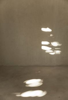 shadows cast on the wall and floor in an empty room with no one sitting or standing