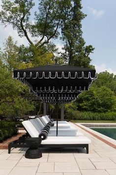 an outdoor lounge chair sitting on top of a white tile floor next to a pool