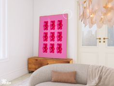 a living room filled with furniture and a pink painting