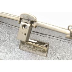 Elegant Judith Leiber silver metal and crystal oblong evening bag clutch featuring a scrolling foliage flower design on a silver - toned metal bag.  The hardware is silver.  It has a silver leather interior with a silver shoulder strap that can be folded inside when you want to wear it as a clutch.  There is a circle that folds out to hold a tassel, but it is no longer there.  Labeled ‘Judith Leiber/New York’ in the interior. 5.5” W x 3” H x 1.5” D  A similar one sold at Chrisities from Joan Riv Designer Evening Bag With Silver-tone Hardware, Glamorous Silver Evening Bag With Silver-tone Hardware, Silver Rectangular Evening Bag With Silver-tone Hardware, Designer Evening Clutch With Silver-tone Hardware, Silver Clutch Evening Bag With Silver-tone Hardware, Metallic Bag, Judith Leiber, Evening Clutch Bag, Leather Interior