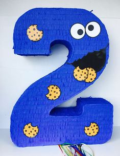 the number two is made out of lego blocks and has cookie cookies on it's face