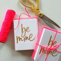 two cards with the words be mine on them next to a spool of thread