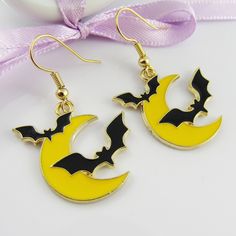 the earrings are decorated with bats on the moon