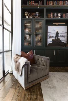 a living room filled with furniture and bookshelves