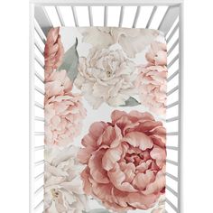 a white crib with pink flowers on it