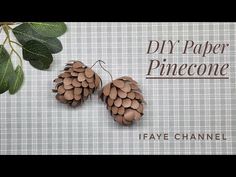 two pinecone shaped earrings with leaves hanging from them