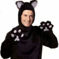 a man in a black cat costume with paws on his chest and hands out to the side