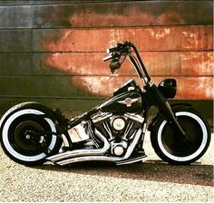 a black and silver motorcycle parked in front of a building