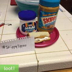 a sandwich on a pink plate next to a jar of peanut butter and a note that says skippy three