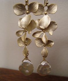 On sale gold or silver orchid earrings, highly detailed shimmering gold petals form pretty floral earrings. made with natural keishi pearls. vermeil earwires. 2.25''long. **available in silver** Please convo me if you would like to customize this piece or order multiples for your bridal party , I would love to hear from you! Delicate Gold Petal Flower Earrings, Gold Flower Chandelier Earrings Elegant Style, Gold Flower-shaped Elegant Chandelier Earrings, Elegant Gold Flower Chandelier Earrings, Gold Petal Flower Earrings For Wedding, Handmade Gold Flower Earrings For Wedding, Elegant Gold Petal Flower Earrings, Elegant Gold Petal Earrings, Elegant Gold Petal-shaped Earrings