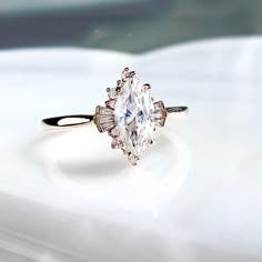 an engagement ring with a pear shaped diamond