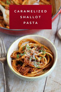 a white bowl filled with pasta and topped with parmesan cheese on the side