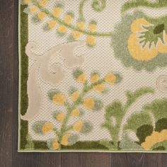 an area rug with yellow and green flowers on it