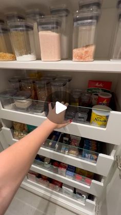 a person reaching for food in the refrigerator