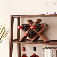 three bottles of wine are sitting on a shelf