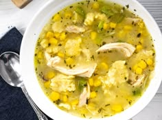 a white bowl filled with chicken and corn soup