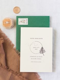 the wedding stationery is laid out on top of a blanket, with stamps and a wax stamp