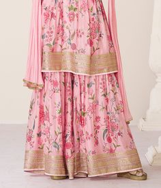 COLOR : Pink FABRIC : Top - Premium Organza Silk, Bottom - Premium Organza Silk, Inner - Santoon, Dupatta - Nazneen WORK : Zari Embroidery, Digital Print, Stones, Sequins, Lace Border OCCASION : Wedding, Reception, Engagement, Party Wear, Festival READY-TO-WEAR : No STITCHING : Available as semi-stitched fabric, can be stitched using standard size option (+$20). Note: There might be a slight color variation due to lighting and flash used during photoshoot. The bright shade seen is the best close Floral Print Semi-stitched Sharara For Reception, Pink Embroidered Palazzo Set For Reception, Long Sleeve Georgette Sets With Floral Print, Long Sleeve Floral Print Georgette Sets, Navratri Floral Print Georgette Sets, Traditional Floral Print Georgette Sharara, Silk Floral Print Sets For Reception, Silk Sets With Floral Print For Reception, Pink Anarkali Palazzo Set With Floral Embroidery