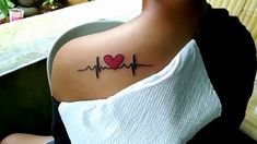 a woman with a heartbeat tattoo on her shoulder