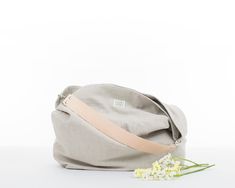 "This beige hobo bag is super lightweight. It's a shoulder purse so comfortable that you won't want to take it off. Also, the wide leather handle does not stick to your shoulder. This shoulder bag is lined with a pink and white striped fabric 100% cotton. Its 100% linen outer fabric is very cool and pleasant for the summer. This spacious, comfortable and lightweight hobo bag is perfect for any time of day and adds style to any outfit. * Materials: - Outside: 100% stonewashed linen. Beige color - Neutral Hobo Bag With Adjustable Strap For Everyday Use, Versatile Beige Hobo Bag With Leather Handles, Neutral Everyday Hobo Shoulder Bag, Neutral Hobo Bag With Adjustable Strap, Neutral Hobo Shoulder Bag For Everyday, Everyday Neutral Hobo Shoulder Bag, Neutral Hobo Shoulder Bag With Adjustable Strap, Everyday Neutral Shoulder Hobo Bag, Everyday Beige Hobo Bag With Leather Handles