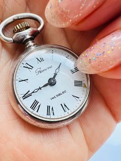 Vintage Sterling Silver Ladies Pocket Watch Sterling Remova Mechanical Hand wound pocket watch Remova vintage pocket watch with 1rd grade silver case, floral engraved decor, mechanical hand-wound movement, white enamel dial, black Roman numericals, outer minute divisions. The diameter of the watch is 2.5 cm, length of the chain 150 cm, weight is 15.3 grams. Hallmark ZI - Dutch hallmark for 925 silver. The watch dates from the middle of the 20th century. The watch runs and is otherwise in perfect Hand Wound, Mechanical Hand, Vintage Pocket Watch, White Enamel, Vintage Sterling Silver, Pocket Watch, Jewellery And Watches, Favorite Jewelry, 925 Silver