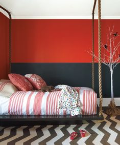 a bedroom with red, black and white striped walls