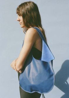 A buttery soft leather tote bag from maryam nassir zadeh with ovular construction and a wide flat strap.    composition | 100% calf leather    dimensions | w 14" x h 22"    made in the usa Chic Blue Bag With Smooth Grain, Modern Blue Soft Leather Hobo Bag, Modern Blue Hobo Bag With Leather Handles, Modern Blue Hobo Bag For Errands, Modern Blue Hobo Tote Bag, Blue Soft Leather Hobo Bag For Errands, Modern Blue Leather Hobo Bag, Blue Leather Shoulder Bag With Rolled Handles, Modern Blue Shoulder Bag With Smooth Grain