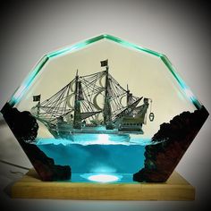 a glass model of a sailing ship in the ocean